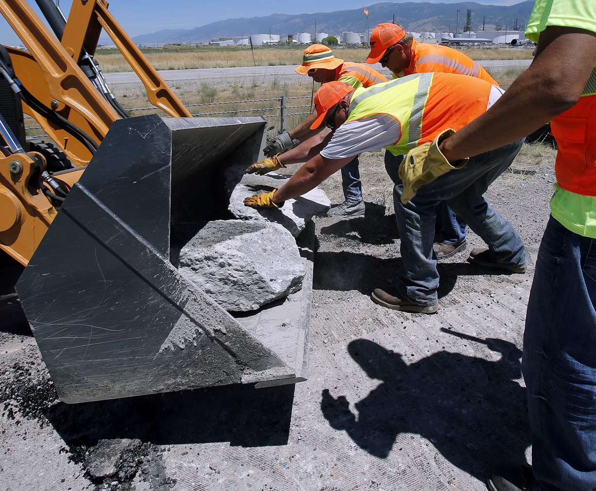 UDOT workers repair road that buckled in the heat on the northwest
corner of I-215 in North Salt Lake on Monday, July 1, 2013.