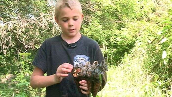 Chase Redfern, 11, holds a 20,000-year-old mastodon molar. He and
three of his friends found the tooth in a river.