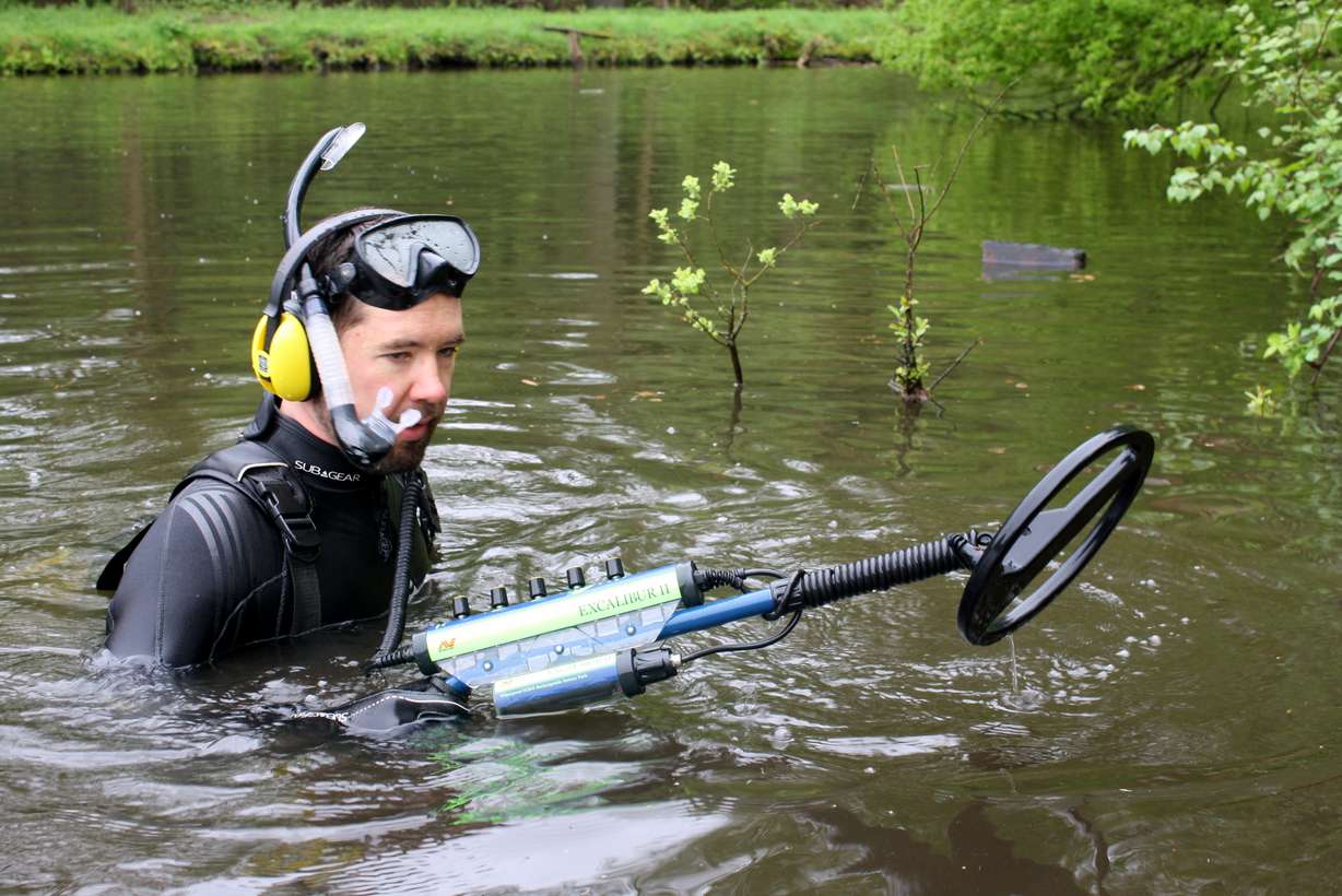 On the first day of searching, Grant Olsen spent hours in the shallow
water near the crash site. He found several metal items, but nothing
from his great-uncle's plane.