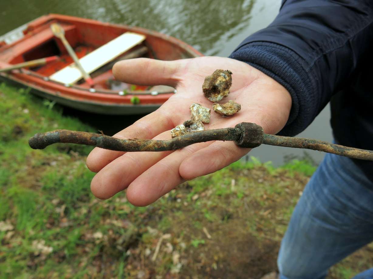 Volker Urbansky displays the copper pipe and aluminum bolts he
found at Grant Turley's crash site. Aviation experts consulted a
detailed parts list and confirmed that they came from a P-47.