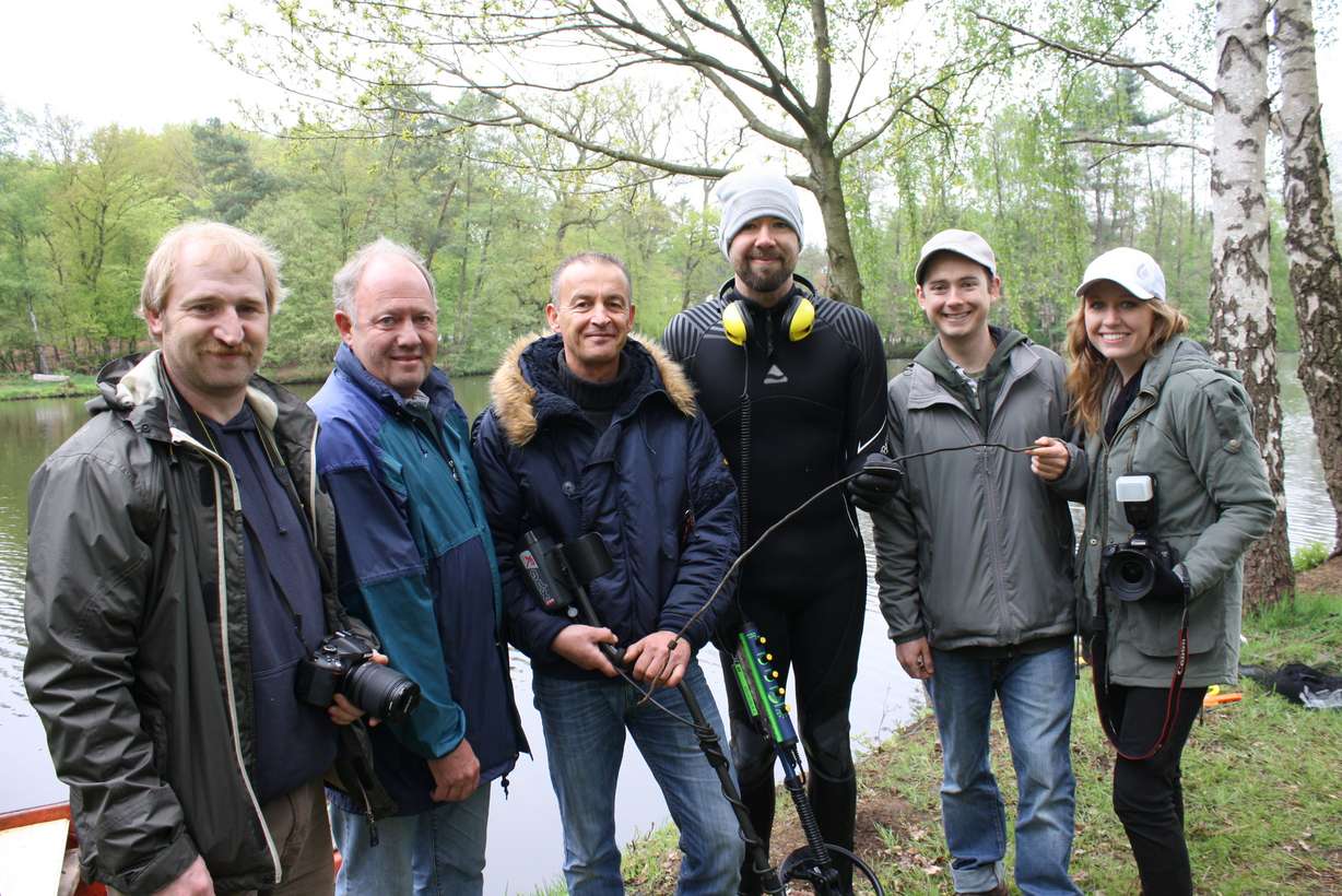 The expedition team poses for a photo at the lake. From left to right
are Christian Klaiss, Hermann Wilke, Volker Urbansky, Grant Olsen, Jon
Olsen and Jennifer Olsen. Not pictured is Werner Oeltjebruns.