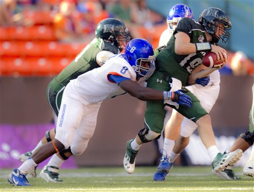 Boise State defensive lineman Demarcus Lawrence (8) grabs Hawaii quarterback Sean Schroeder (19) and tackles Schroeder for a sack in the third quarter of an NCAA college football game Saturday, Nov. 10, 2012, in Honolulu. (AP Photo/Eugene Tanner)