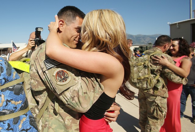 Sr. Airman Tony O'Connor-Geiling proposes to his girlfriend Laura Boyce as 140 members of the 729th Air Control Squadron "Angry warriors" return home from a six-month deployment to Southwest Asia in Layton Sunday, July 21, 2013.