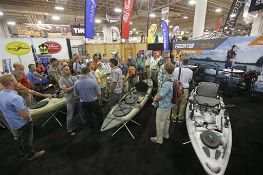 People gather in the Predator exhibit at the
Outdoor Retailer Summer Market Wednesday, July
31, 2013, in Salt Lake City. The world's
largest trade show for outdoor gear is back in
Salt Lake City for a four-day run.