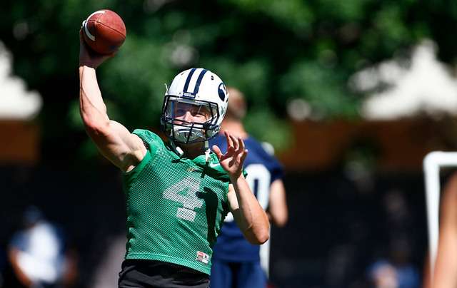 Taysom Hills throws a pass in Saturday's opening session of BYU football camp.