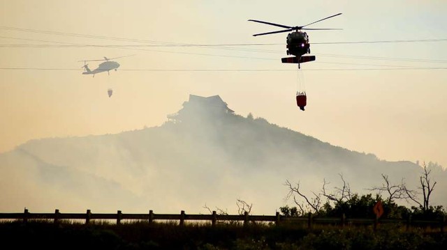 A Black Hawk helicopter drops fire water on the Rockport fire in 
Rockport, Summit County, Wednesday, Aug. 14, 2013. (Scott Jones, 
Deseret News)