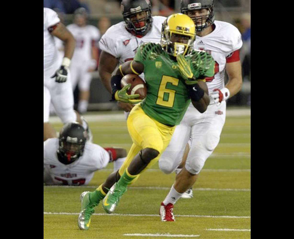 FILE - In this Sept. 1, 2012, file photo, Oregon running back De'Anthony Thomas outruns Arkansas State defenders on his way to a touchdown during the first half of an NCAA college football game in Eugene, Ore. There wasn't a whole lot of theatrics from De'Anthony Thomas in Oregon's opener because he played for less than a half. The sophomore playmaker still managed to show that he's the flash in Oregon's offense. (AP Photo/Don Ryan, File)