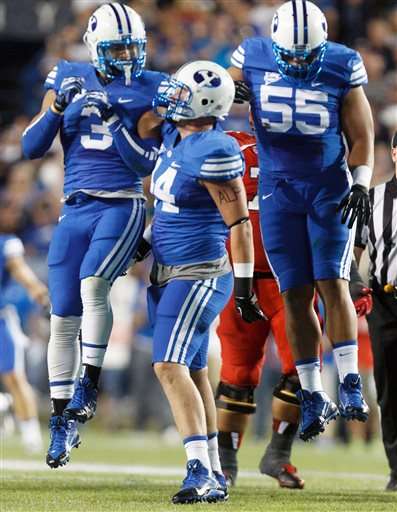 Brigham Young defensive lineman Remington Peck, (44) celebrates his sack of Utah quarterback Travis Wilson (7) with teammates linebacker Kyle Van Noy (3) and Brigham Young defensive lineman Eathyn Manumaleuna (55) in the first quarter of an NCAA football game, Saturday, Sept. 21, 2013 in Provo, Utah. (AP Photo/The Salt Lake Tribune, Trent Nelson)