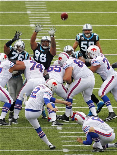 Buffalo Bills kicker Dan Carpenter (2) kicks a 55-yard field goal over 
Carolina Panthers' Greg Hardy (76) and Star Lotulelei (98) in the 
second quarter of an NFL football game Sunday, Sept. 15, 2013, in 
Orchard Park, N.Y. (AP Photo/Bill Wippert)