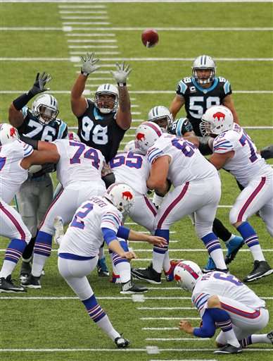 Buffalo Bills kicker Dan Carpenter (2) kicks a 55-yard field goal over
Carolina Panthers' Greg Hardy (76) and Star Lotulelei (98) in the
second quarter of an NFL football game Sunday, Sept. 15, 2013, in
Orchard Park, N.Y. (AP Photo/Bill Wippert)