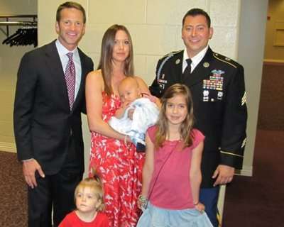 U.S. Rep. Schock, left, Julie Wood, center,
Army Sgt. Brian Wood, right and their three
children