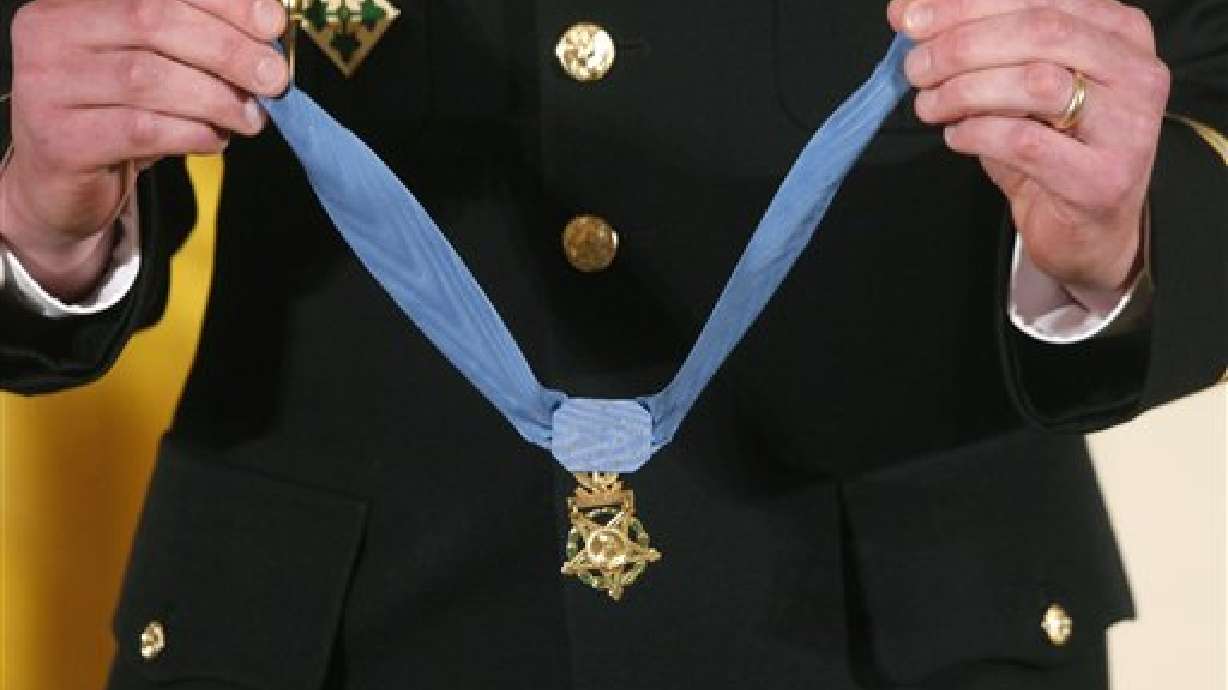 A military honor guard holds the Medal of Honor before President Barack Obama awards it to former Army Capt. William D. Swenson of Seattle, Wash., during a ceremony in the East Room at the White House in Washington, Tuesday, Oct. 15, 2013. Swenson was awarded the Medal of Honor Tuesday for his actions in a lengthy battle against the Taliban in the Ganjgal valley near the Pakistan border on Sept. 8, 2009, which claimed the lives of five Americans, 10 Afghan army troops and an interpreter. (AP Photo/Charles Dharapak)