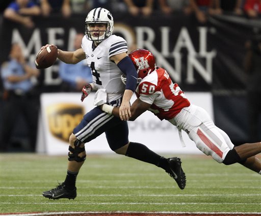 BYU's Taysom Hill (4) is sacked by Houston's Efrem Oliphant during
the second half of an NCAA college football game, Saturday, Oct. 19,
2013 in Houston. BYU defeated Houston, 47-46. (AP Photo/Eric
Christian Smith)