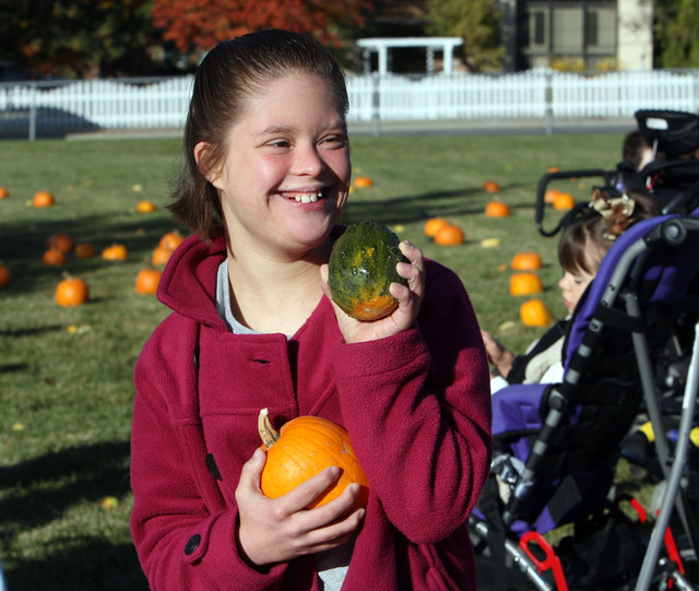 Terese Roa picks out pumpkins at Jordan Valley School in Midvale, 
Monday, Oct. 21, 2013. The pumpkins were provided by the Utah 
State Prison.