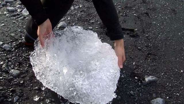 "You can see this is clear ice," Evan Burgess
explained, pointing at a broken chunk of the
glacier. "This is snow that is compressed over
hundreds of years."