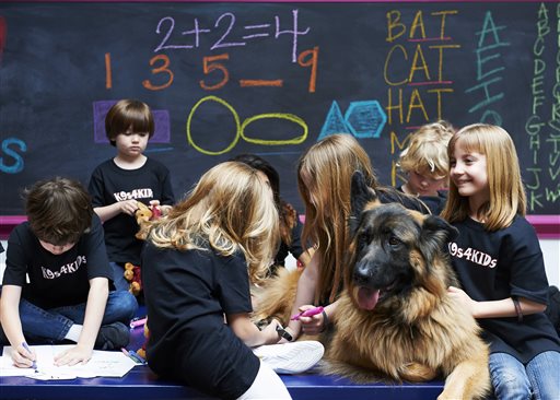 In this Feb. 18, 2013 photo provided by
K9s4KIDS, children share time with canine
mascot Johnny Cash at the TutorVille HUB in
Houston. Schools have beefed up security,
staged mock drills and added metal detectors,
cameras and alarms to prevent violence. Some
think teachers should be armed and the
National Rifle Association wants armed police
in every American school. Kristi Schiller
thinks some special dogs might do the trick.
She wants her charity, K9s4KIDS, to do for
schools what it's done for police departments
in the U.S. - place scores of trained dogs
among their ranks through the nonprofit set
up in 2009. (AP Photo/K9s4KIDS, Josh Welch)