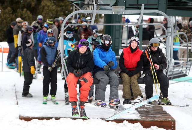 Skiers and snowboarders ride the lift on opening day at Brighton
Resort on Thursday, Nov. 7, 2013.