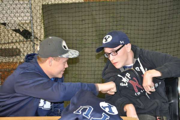Bo Burrup, left, signs with BYU baseball. His friend, Buddy is on the
right. (Photo: Burrup family)