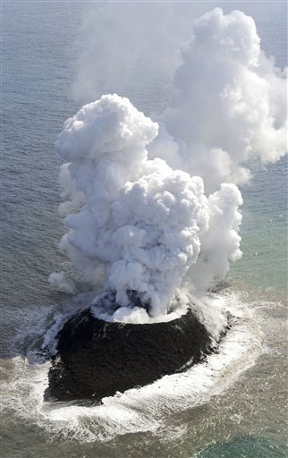 Smoke billows from a new island off the coast
of Nishinoshima, a small, uninhabited island
in the Ogasawara chain, far south of Tokyo
Thursday, Nov. 21, 2013. The Japan Coast
Guard and earthquake experts said a volcanic
eruption has raised the new island in the
seas to the far south of Tokyo. The coast
guard issued an advisory Wednesday warning of
heavy black smoke from the eruption.