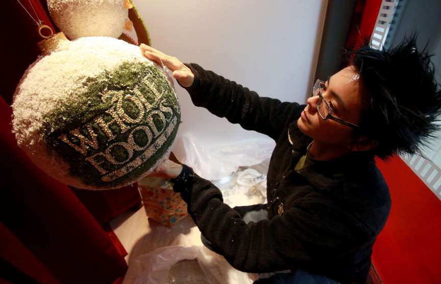 Davida Wegner, graphic artist for Whole Foods
at Trolley Square, puts finishing touches on
Macy's Candy Windows at Macy's City Creek in
Salt Lake City on Thursday, Nov. 21, 2013.
Whole Foods donated the candy for the display.