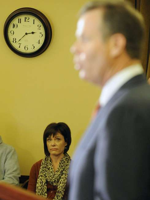 Utah Attorney General John Swallow's wife,
Suzanne, listens as her husband announces his
resignation during a press conference at the
Capitol in Salt Lake City on Thursday, Nov. 21,
2013