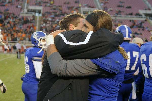 Bingham's Kyle Gearig, left, hugs teammate Bingham's Kade Jensen after Jensen replaced Gearig at the quarterback position after getting injured earlier in the game against the Brighton Bengals during the 5A State Championships at Rice Eccles Stadium on Friday, November 22, 2013. (MATT GADE, Deseret News)