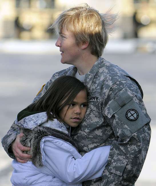 Nine-year-old Leilani Ward gives a big hug to Chief Warrant Officer 3 Kayce Lowry before Lowry prepares to fly out with eight other soldiers of the Utah Army National Guards 2nd Battalion, 211th Aviation, on two UH-60 Blackhawk helicopters for the first leg of their 12-month deployment to Kosovo from the Utah Guards Army Aviation Support Facility in West Jordan on Saturday, November 23, 2013. The remaining 49 soldiers will join up with their unit on Sunday as they will leave from Salt Lake International Airport and rendezvous at Fort Hood in Texas.