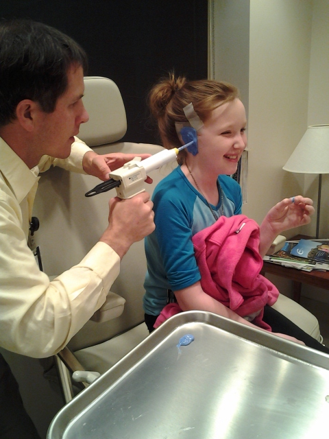 Girl born without ear receives prosthetic, gives forward