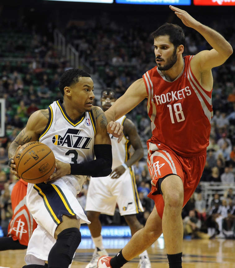 Utah Jazz point guard Trey Burke (3) drives to the basket as Houston Rockets small forward Omri Casspi (18) defends during a game at EnergySolutions Arena on Monday, December 2, 2013. (Matt Gade/Deseret News)