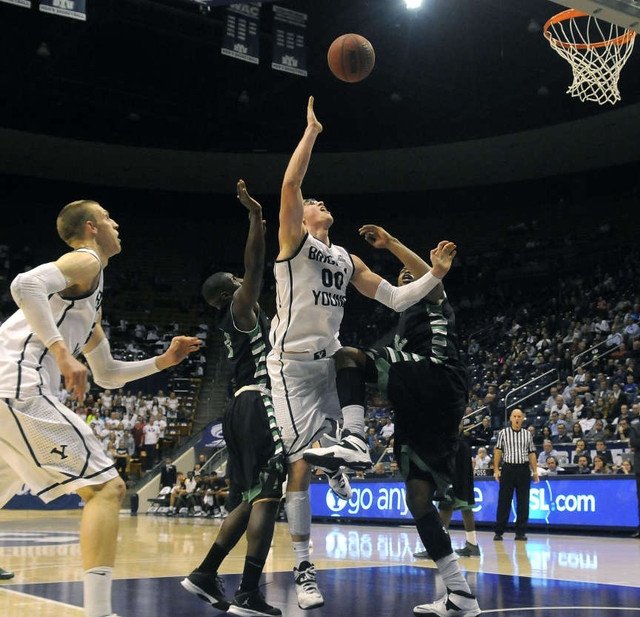 Brigham Young Cougars forward Eric Mika (00) is fouled going to the basket during a game at the Marriott Center in Provo on Tuesday, December 3, 2013.