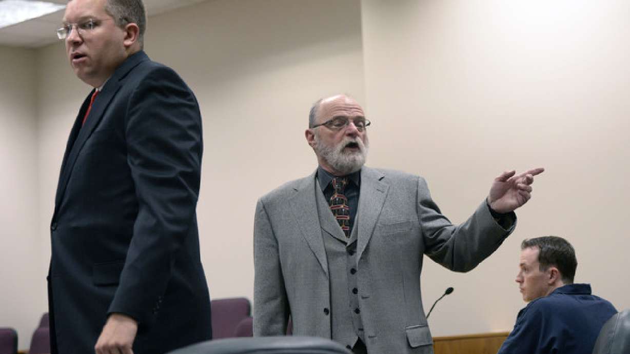 Prosecutor Craig Johnson, left, and defense attorney Ron Yengich speak to a judge in court hearing for Conrad Truman on Dec. 6, 2013. An appeals court has revived a lawsuit Truman filed against Johnson.