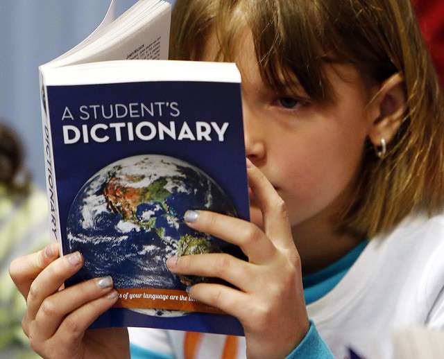 Ainslee Zumwalt reads after receiving a personal dictionary at NIbley
Park Elementary School in Salt Lake City, Wednesday, Dec. 4, 2013, as
part of The Dictionary Project.