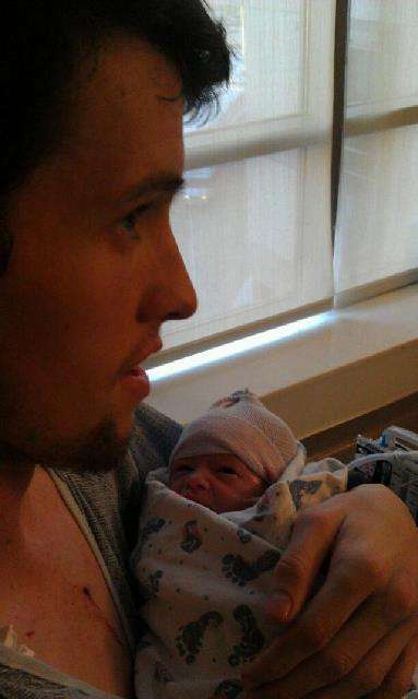 Josh Robinson held his new son, Logan, for a brief time just after Logan was born. Hours later, Josh slipped into unconsciousness and died the next day. (Photo: Jodi Robison)