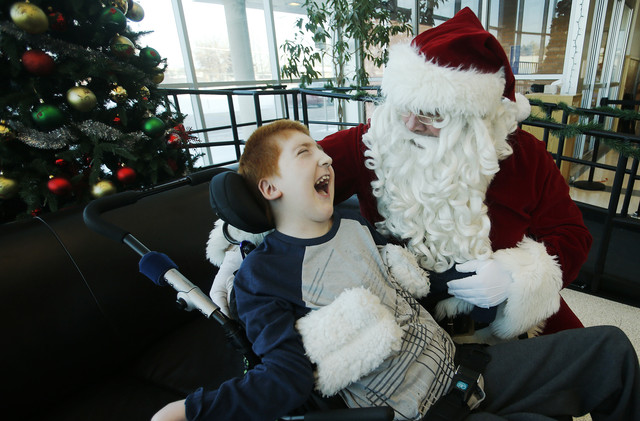 Kauri Sue Hamilton School student Bubba Glowski has some fun with
Santa Claus at the school in Riverton Tuesday, Dec. 17, 2013.