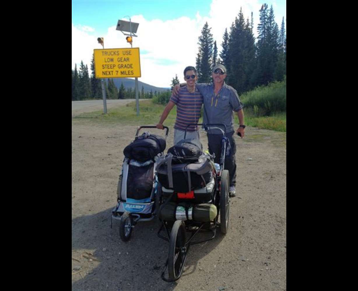 This August 2013 photo provided by Benjamin Lee shows him, left,
and Joe Bell on the side of the road in Colorado. "Hurry up, old man,"
Lee would tease Joe, though, in these high elevations, he was happy
for an excuse to slacken the pace a bit. "I really admire this young
man," Bell wrote of Lee on his blog. (AP Photo/Benjamin Lee)