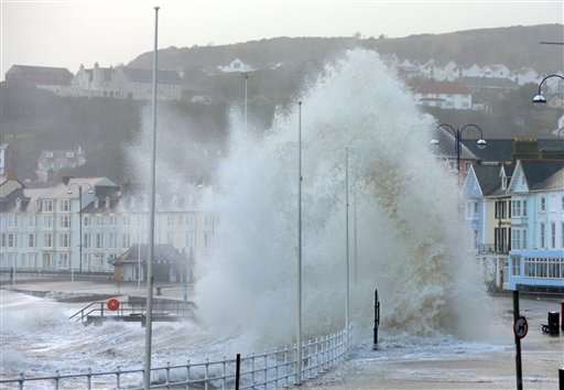 Waves crash against the promenade in
Aberystwyth, Wales Monday Jan. 6, 2014 as
strong winds and high tides continue in
western Britain . Weather forecasting body
the Met Office warned of wind gusts of up to
70 mph (113 kph), accompanied by
exceptionally large waves, along the coasts
of Wales, southwest England and Northern
Ireland on Monday. The Environment Agency
issued a severe flood warning meaning there
is a threat to life and property — for the
county of Dorset in southwestern England, as
well as more than 300 less serious flood
warnings and alerts.