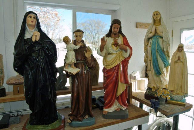 Smashed statues restored, returned to church