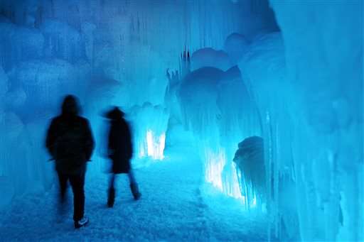 In this Wednesday, Jan. 8, 2014 photo,
patrons
tour an ice castle at the base of the Loon
Mountain ski resort in Lincoln, N.H. The ice
castle begins to grow in the fall when the
weather gets below freezing and thousands of
icicles are made and harvested then placed
around sprinkler heads and sprayed with
water. The castle will continue to grow as
long as the temperatures stay below freezing.
