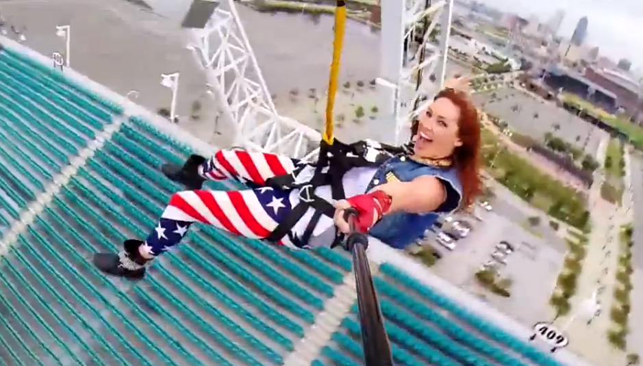 A woman zip-lines off a tower over Everbank Field. Photo credit: Devin
Graham