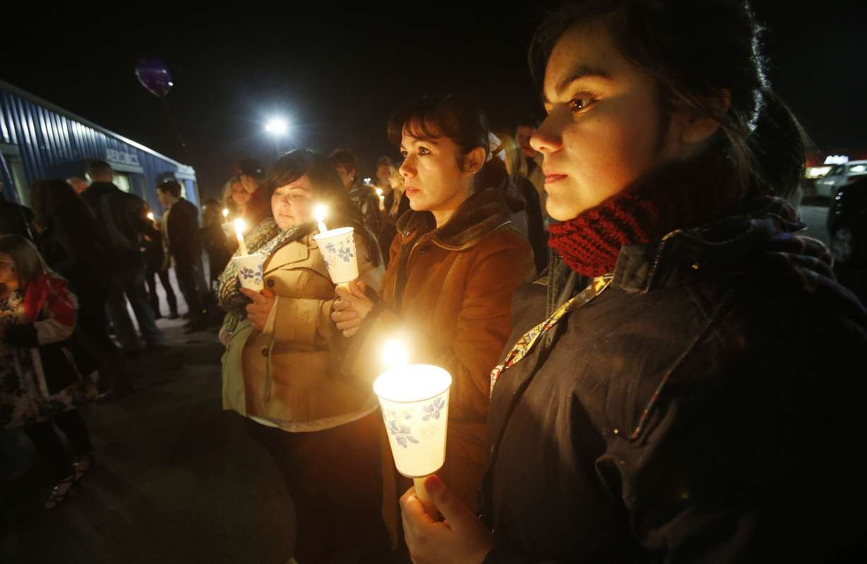 Rachel Acosta, Raquel Acosta and Monika Gamble
hold candles during a memorial to honor
murdered Boren family members in Spanish Fork
Saturday, Jan. 18, 2014. (Jeffrey D. Allred,
Deseret News)