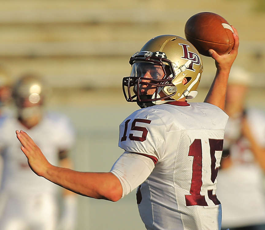 Lone Peak's Baron Gajkowski tries to make a pass as he scrambles out 
of the pocket as Alta and Lone Peak play Friday, Aug. 30, 2013 at Alta.