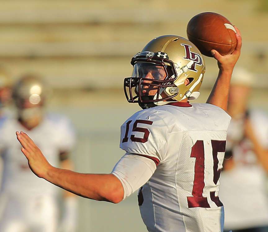 Lone Peak's Baron Gajkowski tries to make a pass as he scrambles out
of the pocket as Alta and Lone Peak play Friday, Aug. 30, 2013 at Alta.