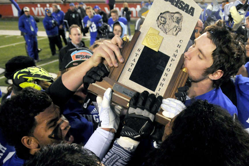 Bingham's Dalton Schultz kisses the championship trophy following 
the presentation ceremony during the 5A State Championships at Rice 
Eccles Stadium on Friday, November 22, 2013.