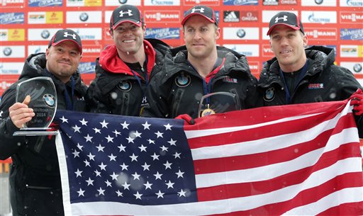 Steven Holcomb of the United States, from left, poses with his team Curtis Tomasevicz, Steven Langton and Christopher Fogt after winning their four-man Bobsled World Cup race in Koenigssee, southern Germany, on Sunday, Jan. 26, 2014. (AP Photo/Matthias Schrader)