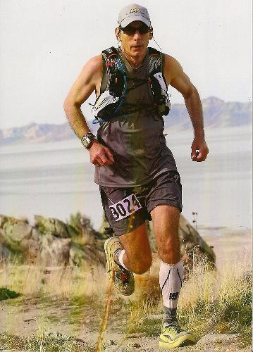 Man completes 100-mile race a year after beginning cancer treatments