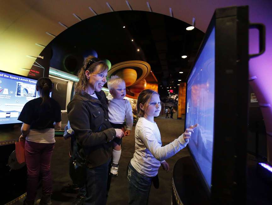 Ladonnalee McKendrick and her children Rustin and Arianna build a rocket on NASA's Exploration Systems traveling exhibit at the Clark Planetarium in Salt Lake City, Wednesday, Feb. 26, 2014. (Ravell Call, Deseret News)