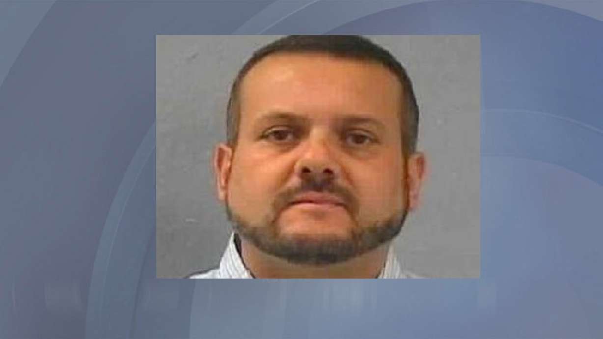 Professor charged with taking locker room photos