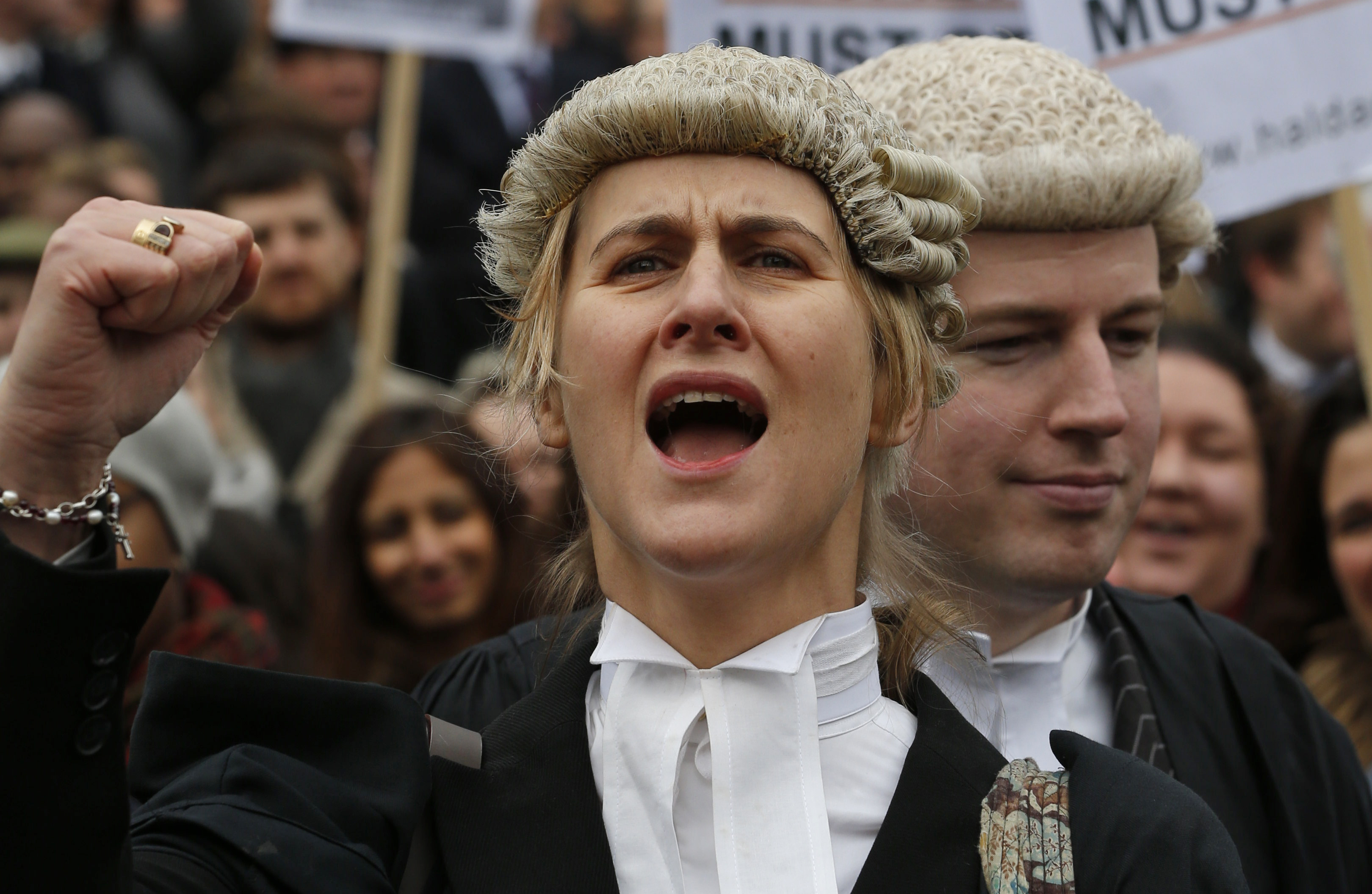 Bewigged British lawyers march to protest fee cuts