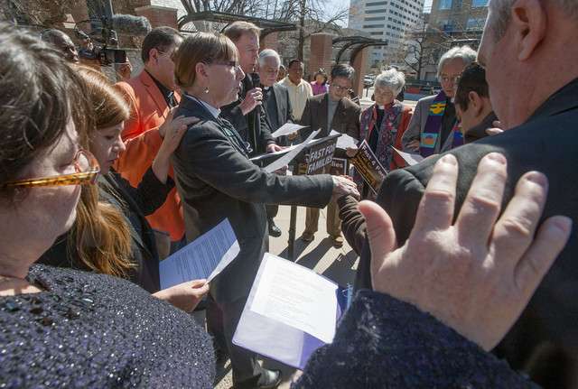 Salt Lake City Catholic Bishop John Wester
leads other Utah faith leaders in prayer to
bless DJ Yoon and Rudy Lopez at the Episcopal
Church Center, 75 South 200 East, as Yoon and
Lopez will drive the Fast for Families Across
America tour bus for immigration reform on
Saturday, March 8, 2014. (Photo: Matt Gade,
Deseret News)