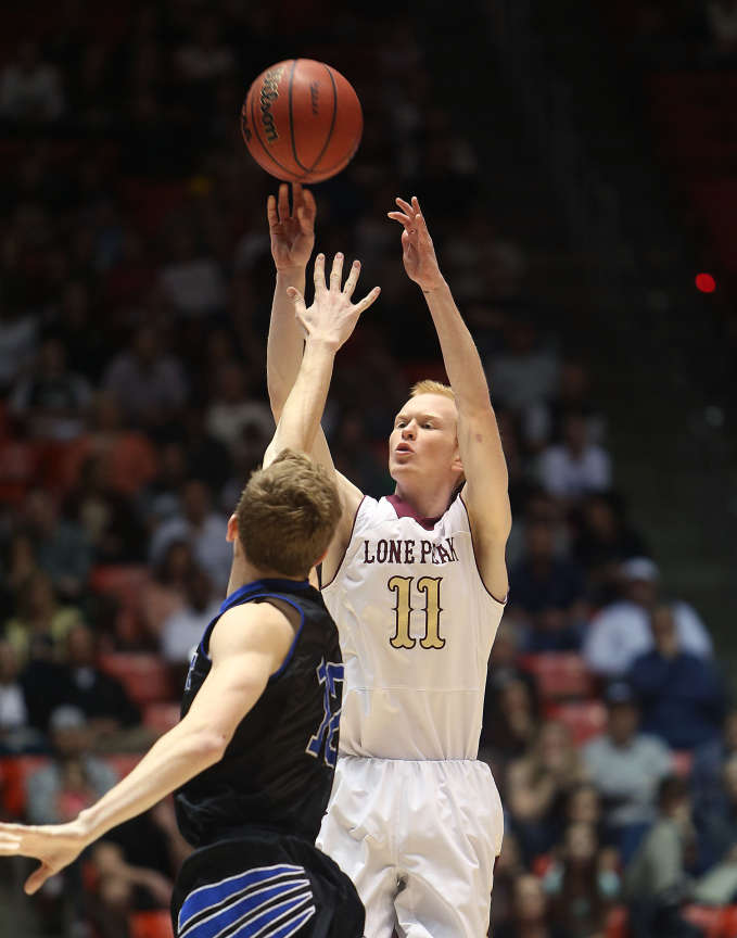 Lone Peak's TJ Haws puts in one of his eight
three point shots as the Knights won their
fourth straight 5A championship